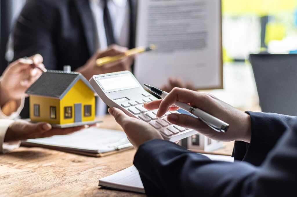 Immobilienmakler berechnet mit dem Kunden den Wert der Immobilie.
